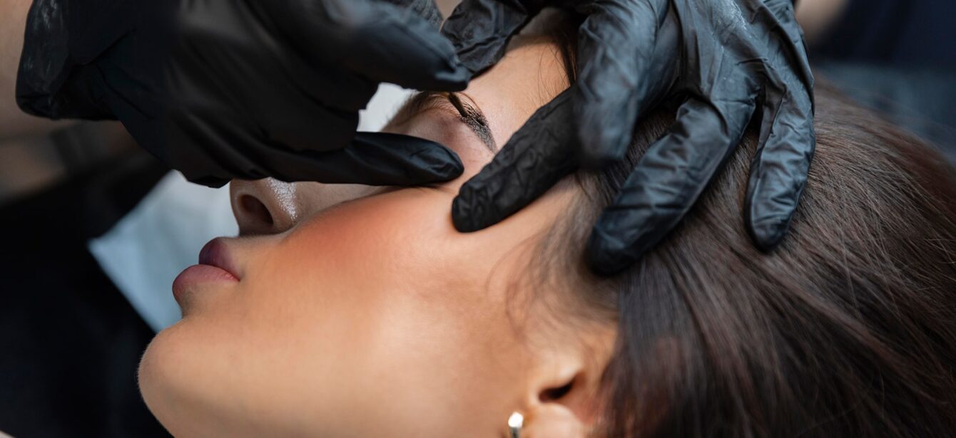 young-woman-getting-beauty-treatment-her-eyebrows young-woman-getting-beauty-treatment-her-eyebrows
